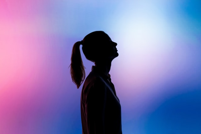 silhouette of a young woman with colorful lights
